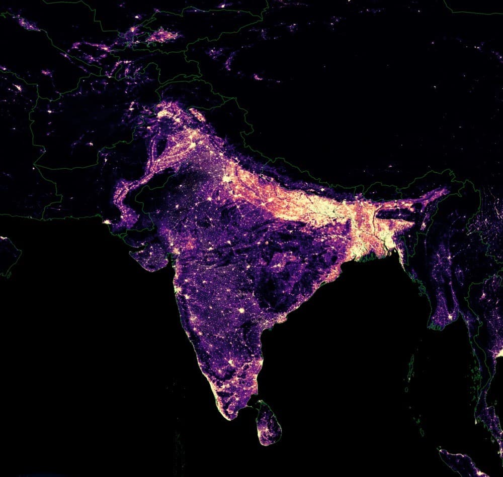 Population density map of South Asia rendered as a night-light heat map. The Indo-Gangetic plain burns brightest, showing extreme population concentration across northern India and Bangladesh.